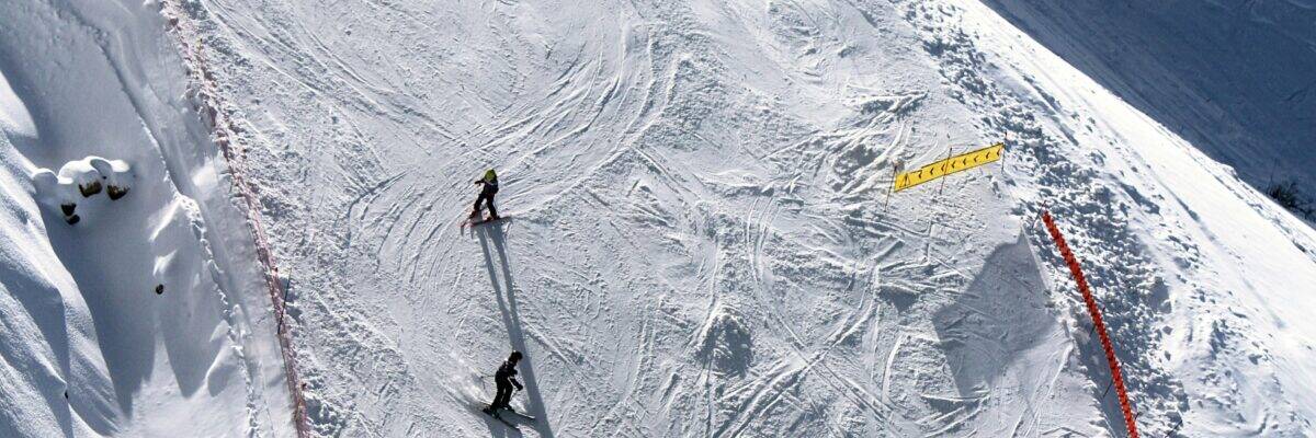 Aerial view of skiers on a snowy piste in Les Deux Alpes