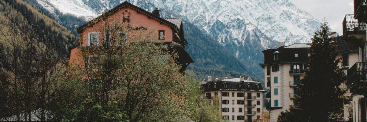 Buildings near trees and glacier mountains in Chamonix